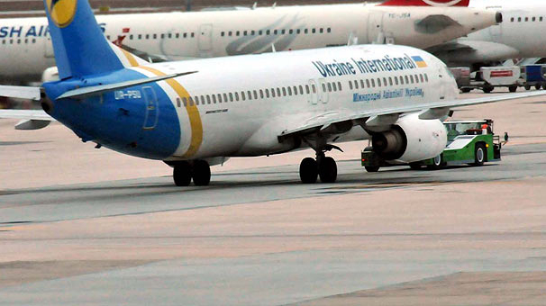 Сотрудники службы безопасности международного аэропорта Ататюрка в Стамбуле осуществляют проверку двух украинских самолетов после сообщения о бомбе на борту. 
